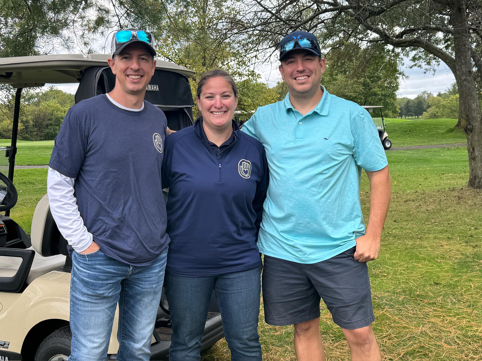Steph with brothers Joe and Mike at the charity golf tournament