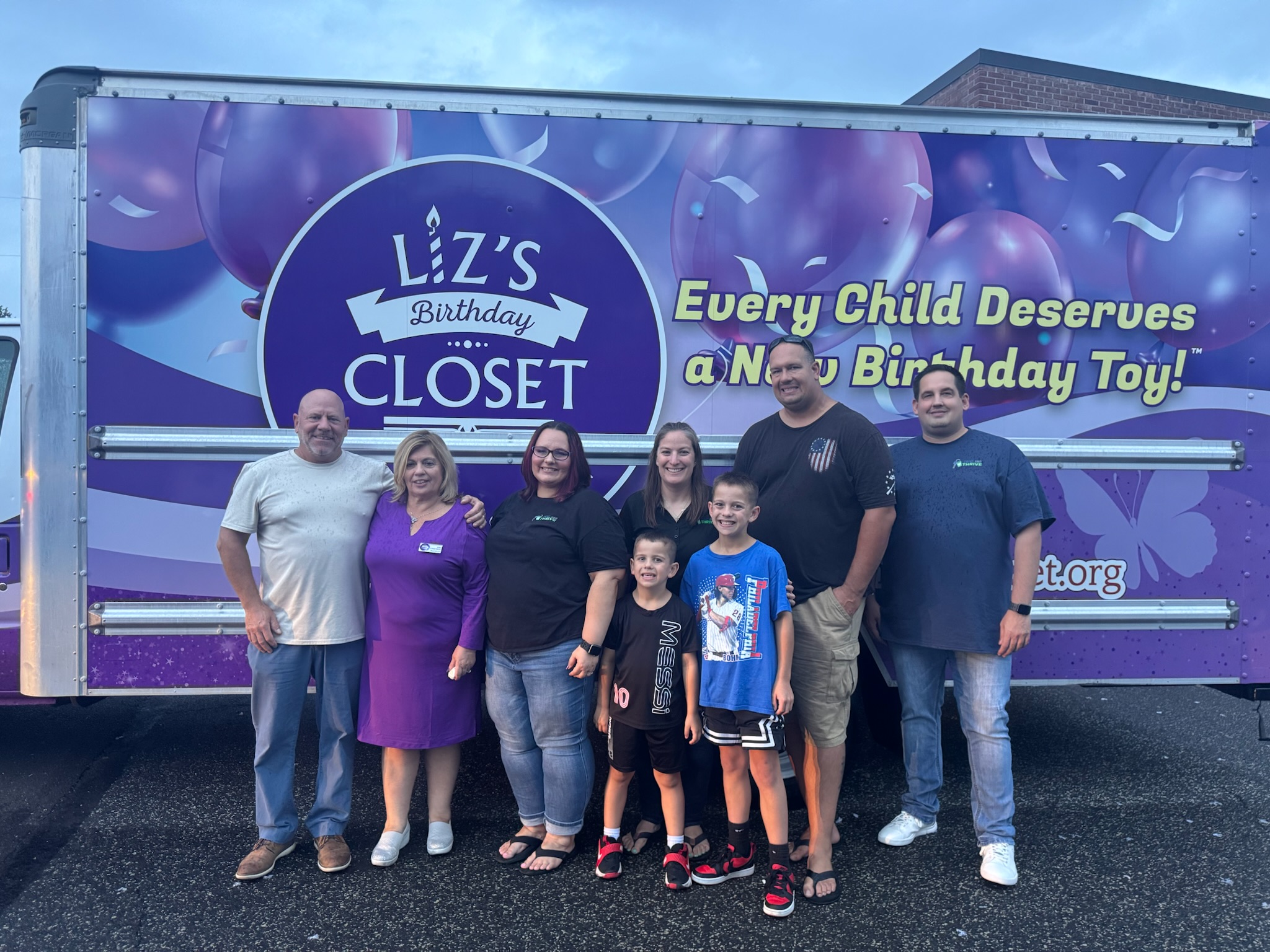 Group in front of Liz's Birthday Closet box truck